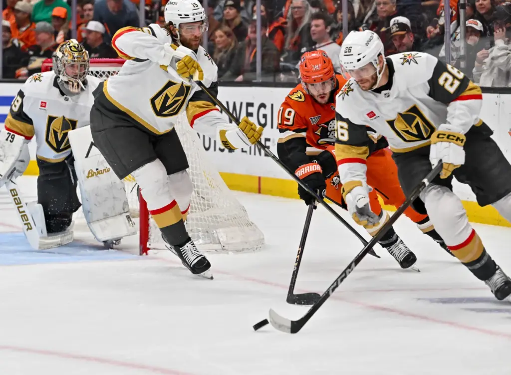 The Ducksâ Troy Terry (19) battle for the puck with...