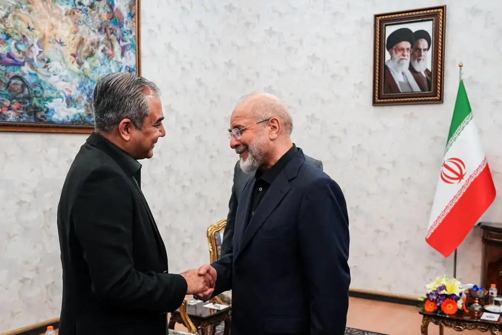 Iran’s Parliament Speaker Mohammad Bagher Qalibaf, right, shakes hands with...