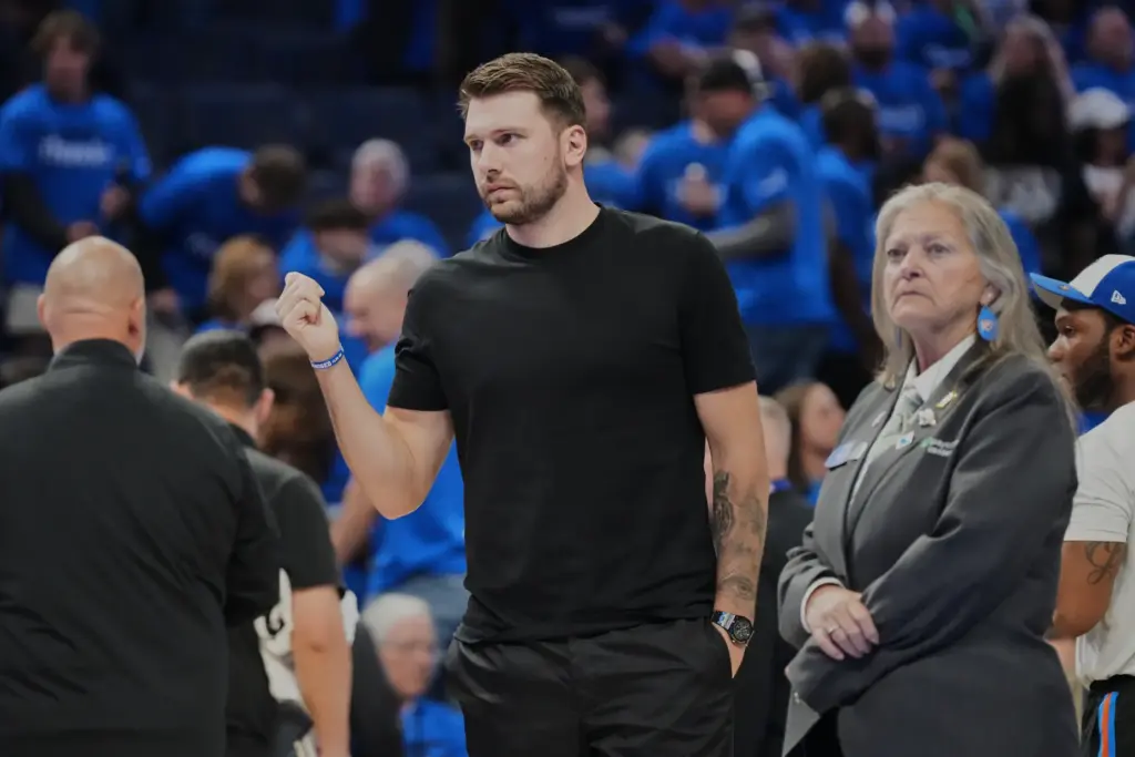 Injured Lakers star Luka Doncic stands on the court during...
