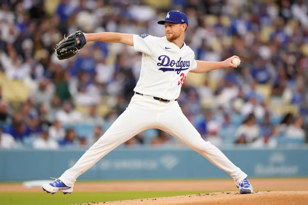 Dodgers starting pitcher Eric Lauer throws to the plate during...