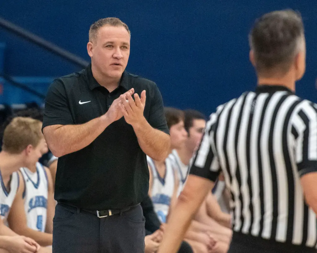 Corona del Mar’s head coach Jason Simco cheers his team...