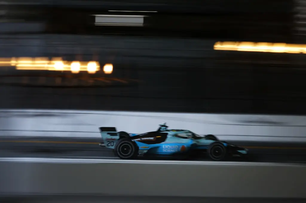 Indycar driver Alexander Rossi speeds down the backstretch in a...