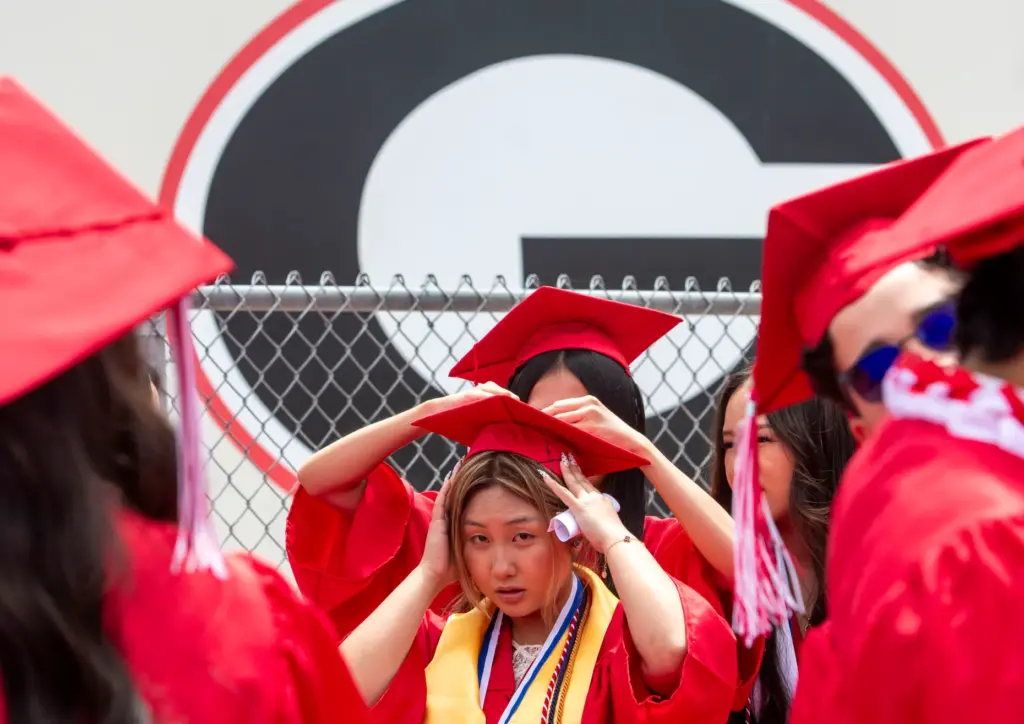 Ngan Nguyen gets her cap secured under the schoolâs big...