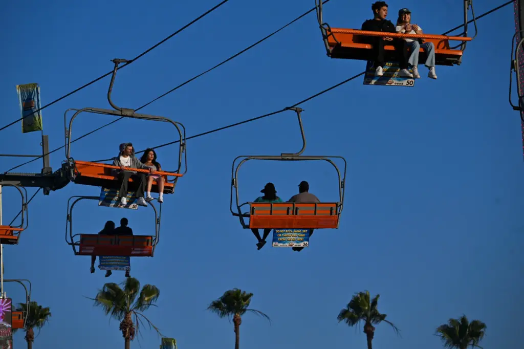 Fairgoers enjoy the rides during the final weekend of the...