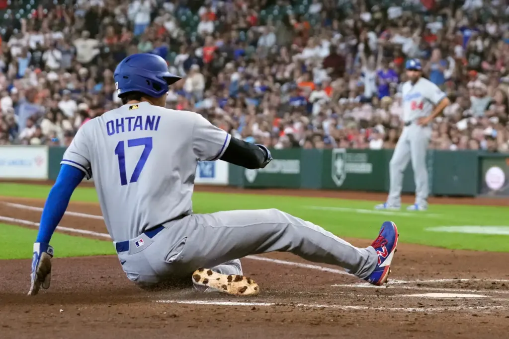 Dodgers star Shohei Ohtani scores during the third inning of...
