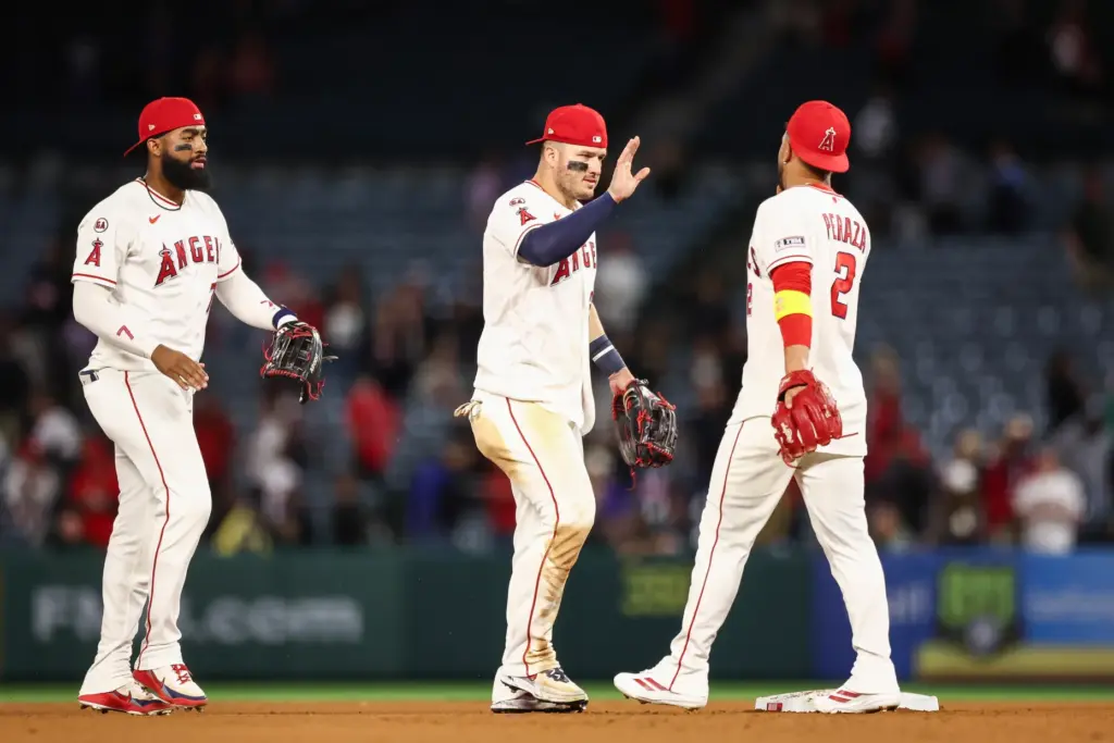 Angels center fielder Mike Trout, middle, celebrates with second baseman...