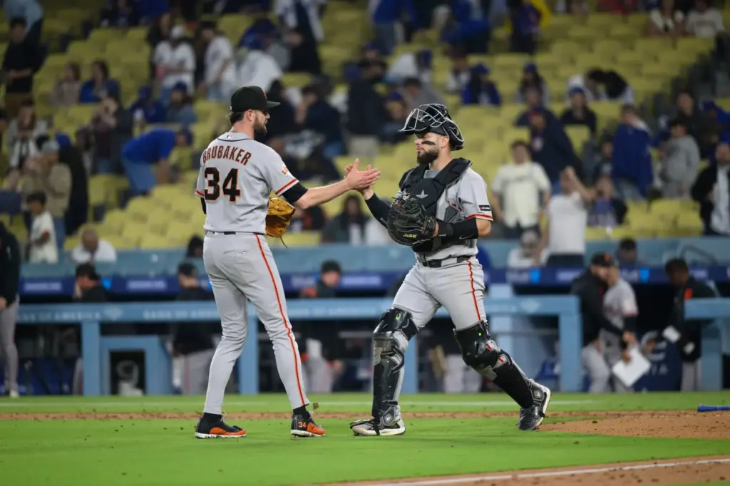 San Francisco Giants relief pitcher JT Brubaker, left, and catcher...