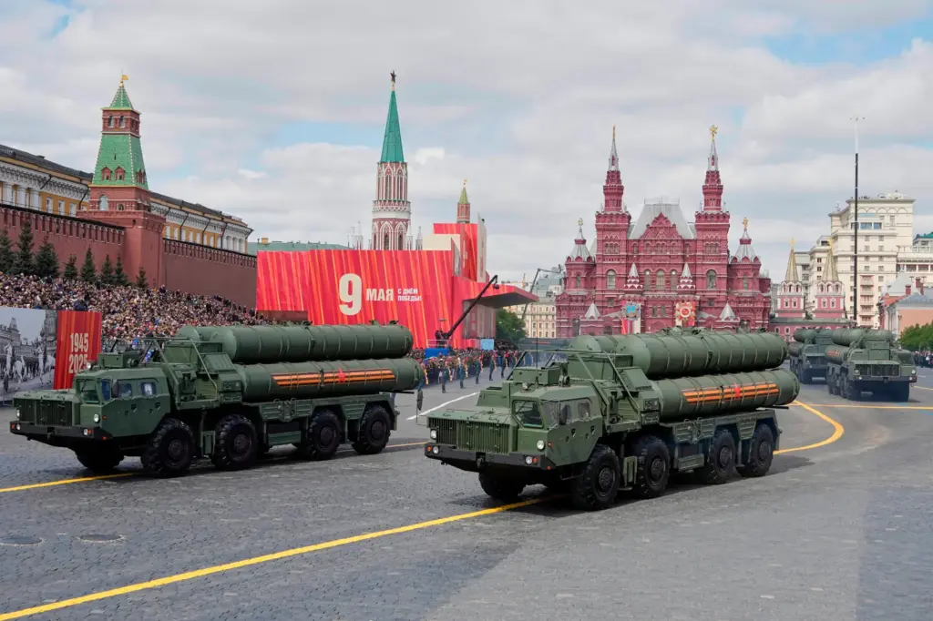 FILE – Russian S-400 anti-aircraft missile system launchers roll during...