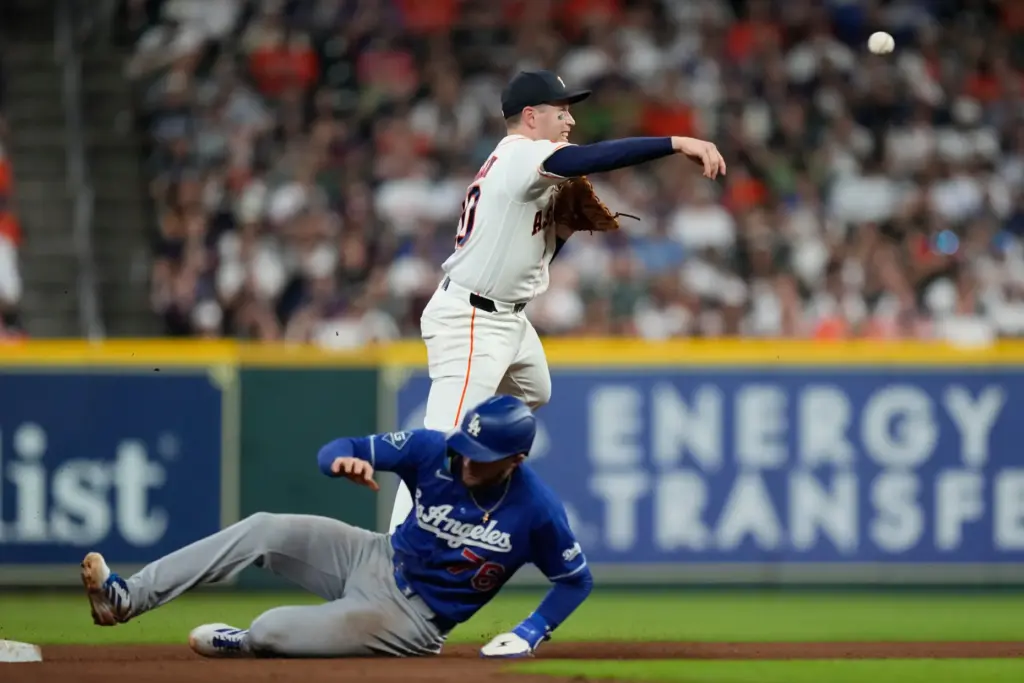 Houston Astros shortstop Nick Allen throws to first base after...