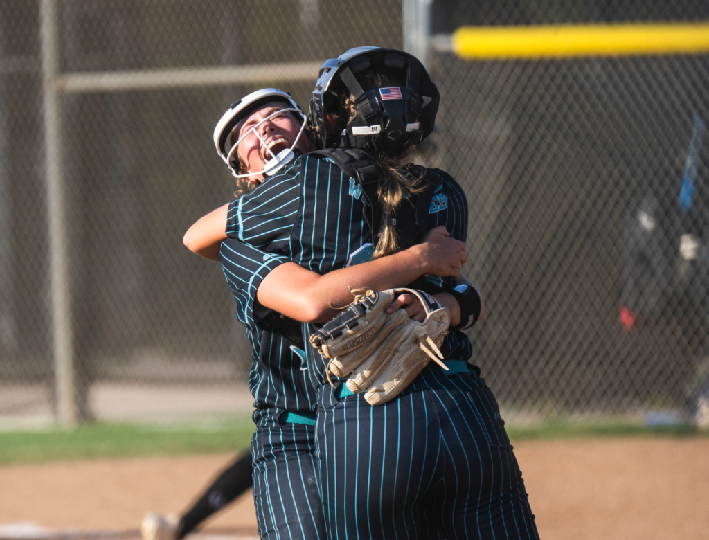 Aliso Niguel’s Amanda Elkins, right, celebrates with catcher Tessa Cowsill...