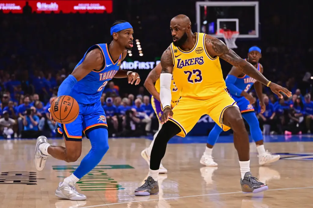 Oklahoma City Thunder guard Shai Gilgeous-Alexander drives as Lakers star...