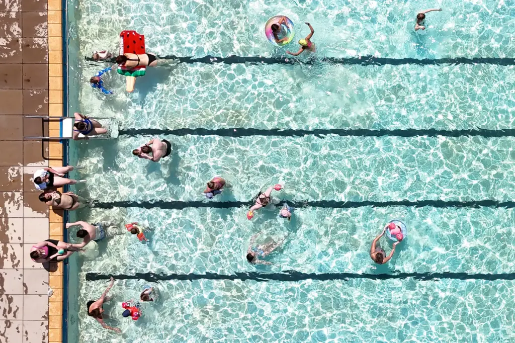 Swimmers keep cool in the hot weather in an open-air pool in Letchworth Garden City.