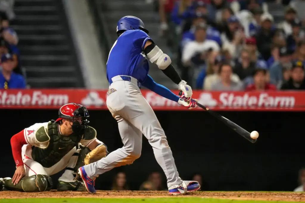 Dodgers’ Shohei Ohtani, right, hits a two-run triple as Los...