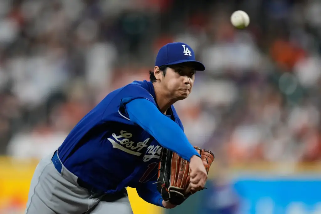 Dodgers starting pitcher Shohei Ohtani throws to the plate during...