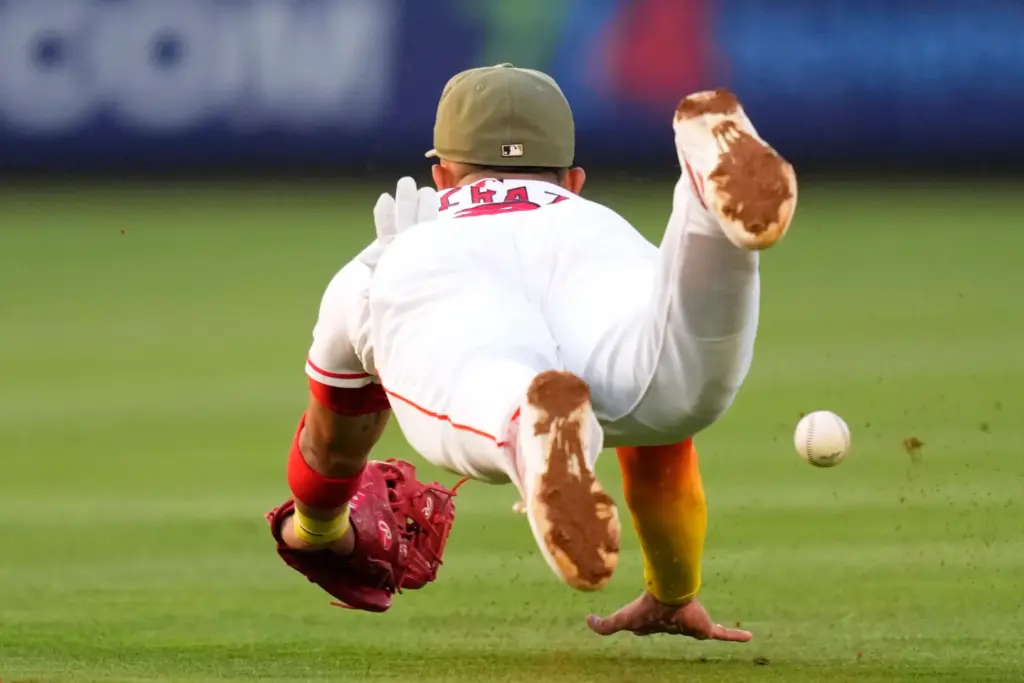 Angels second baseman Oswald Peraza can’t get to a ball...
