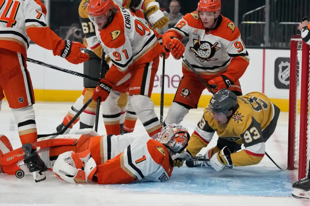 Ducks goaltender LukÃ¡Å¡ DostÃ¡l, surrounded by his teammates, falls to...