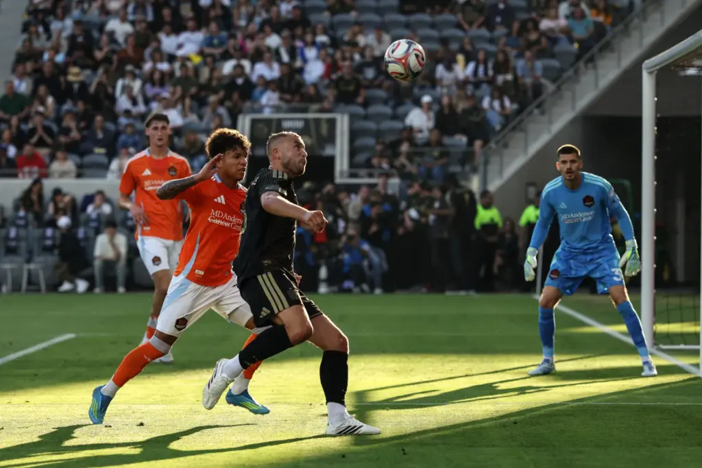 LAFC defender Ryan Porteous, front, chases the ball defended by...