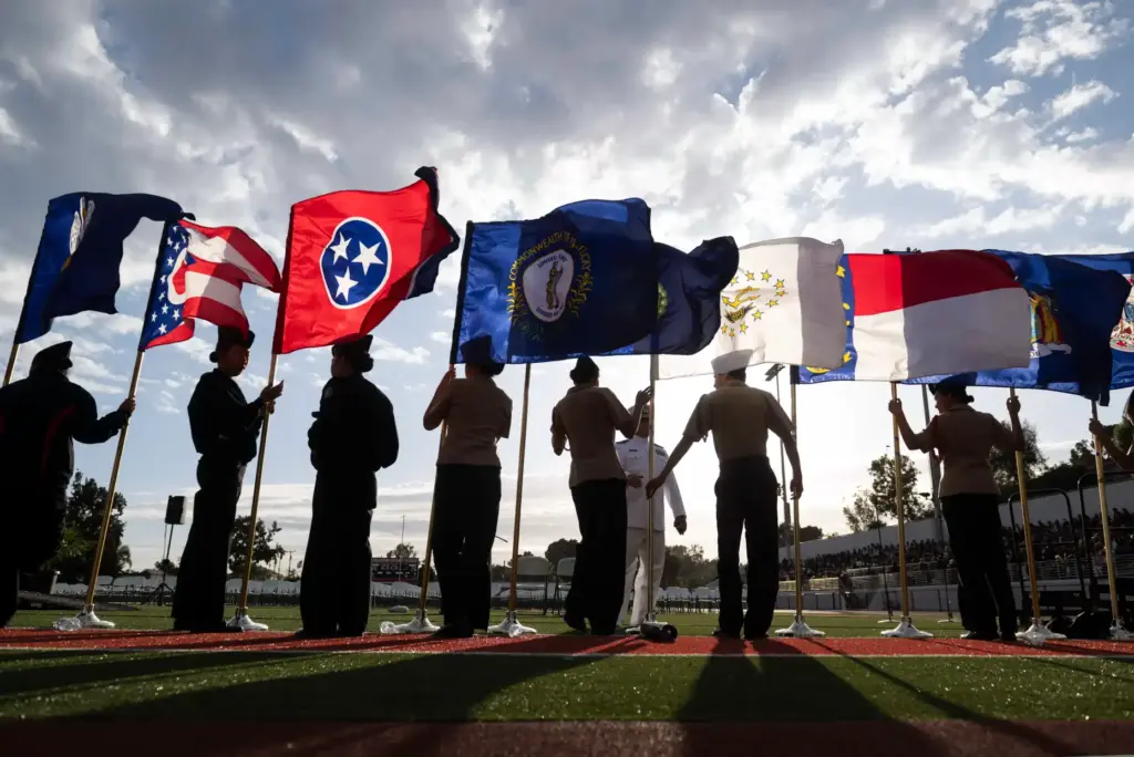 The Troy Navy JROTC cadets display the state flags at...