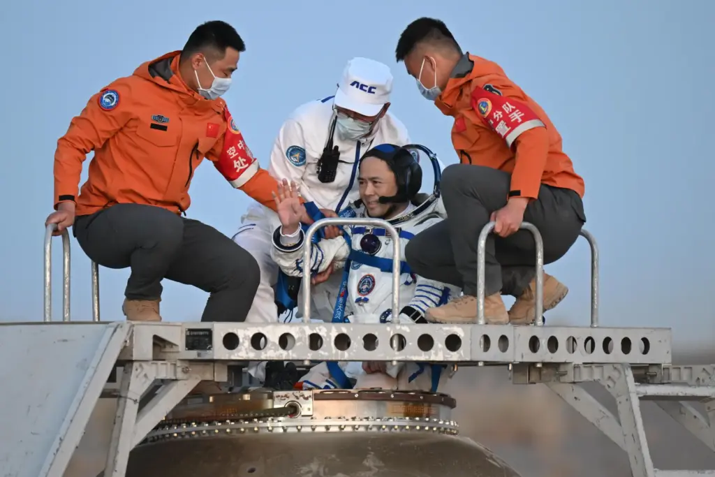 astronaut Zhang Lu, commander of Shenzhou-21 crews waves