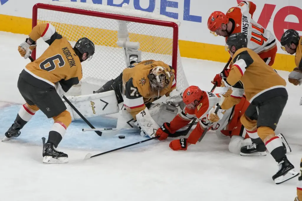 Ducks center Jansen Harkins (24) falls to the ice while...