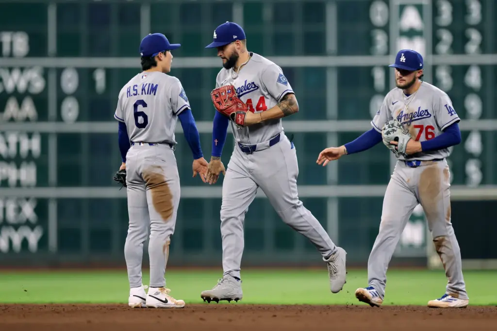 Dodgers shortstop Hyeseong Kim, left, congratulates center fielder Andy Pages...