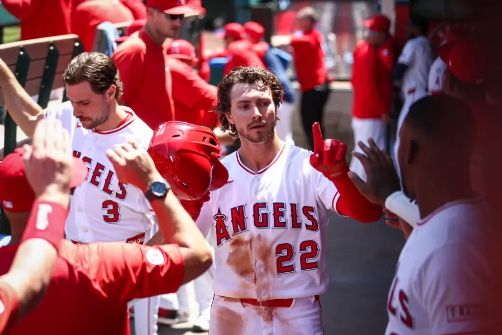 The Angels’ Bryce Teodosio celebrates with teammates in the dugout...