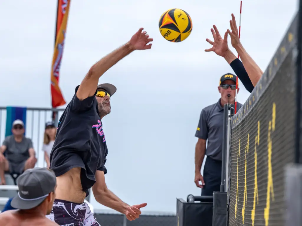 Phil Dalhausser, left, hits the ball while playing with teammate...