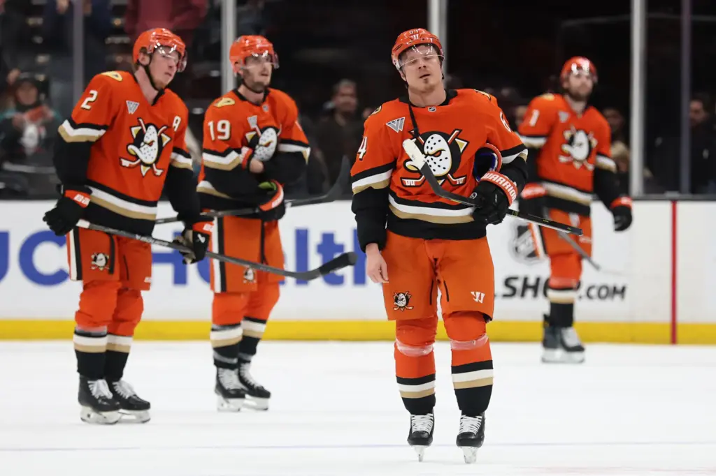 The Ducks’ Mikael Granlund, front, and teammates Jackson LaCombe (2)...