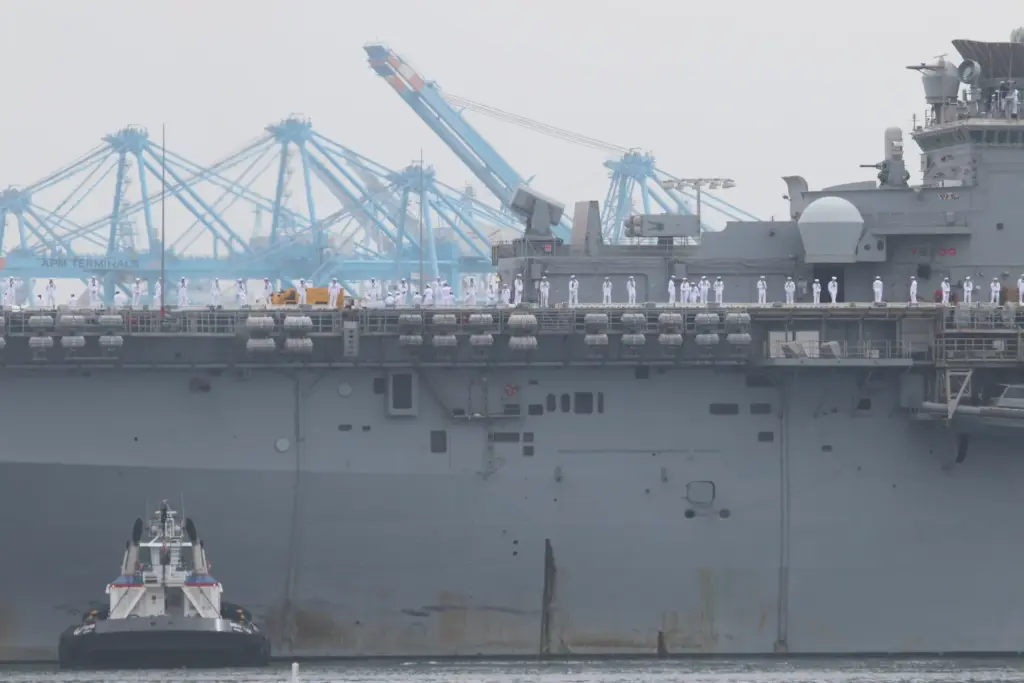 Sailors man the rails as the USS Essex arrives in...