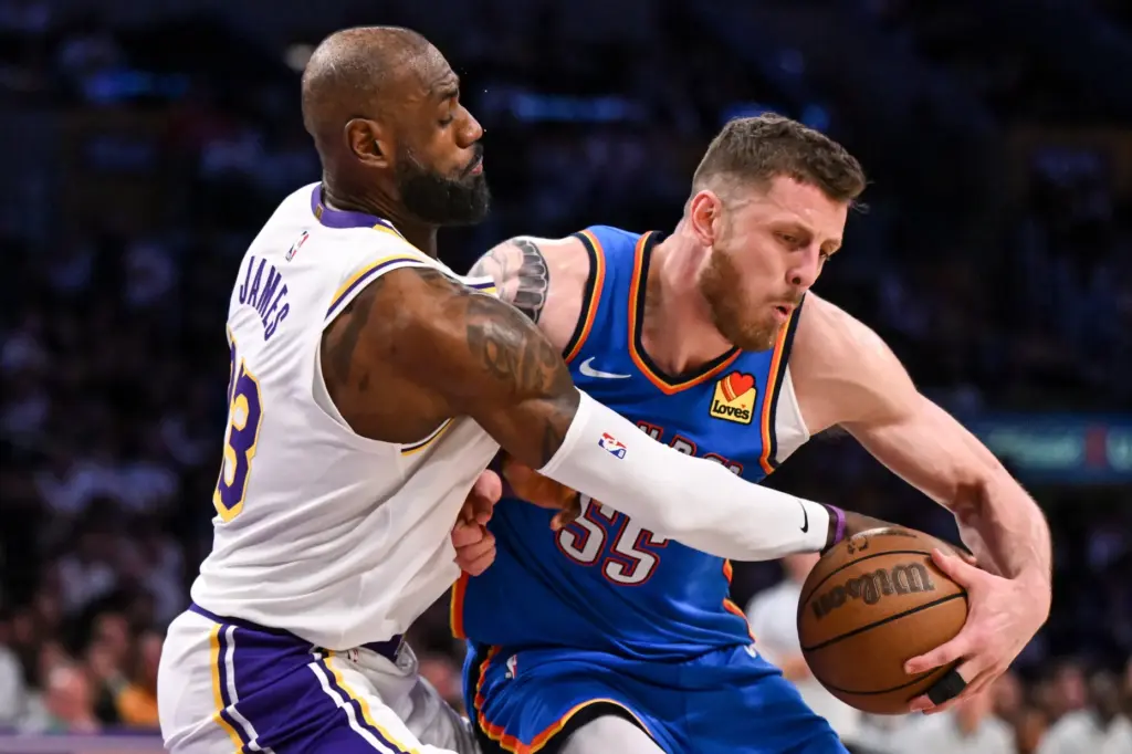 Lakers star LeBron James, left, defends against Oklahoma City Thunder...