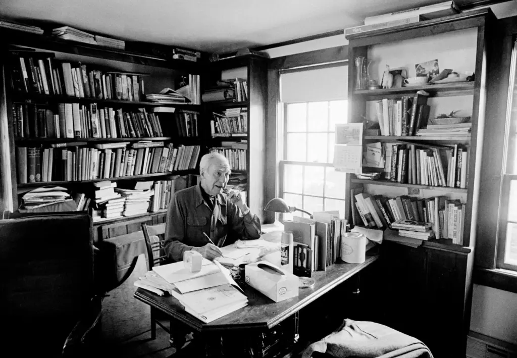 Dr. John Rock developer of the birth control pill, sits at his desk at home