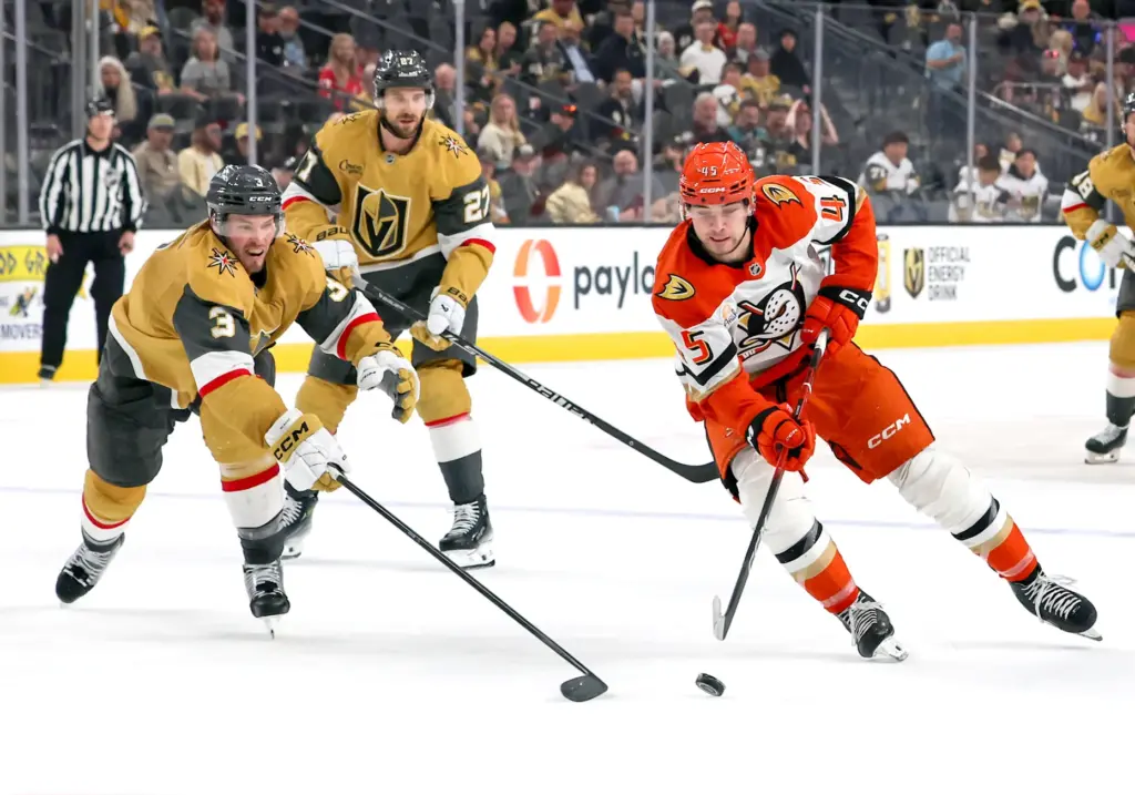 The Ducks’ Beckett Sennecke, right, skates with the puck as...