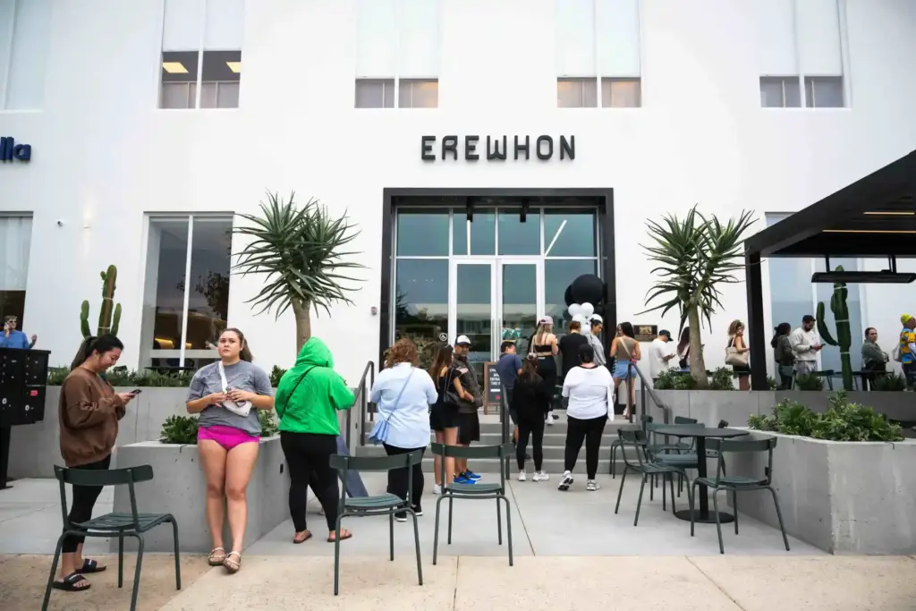 People wait to enter the high-end grocery store Erewhon during...