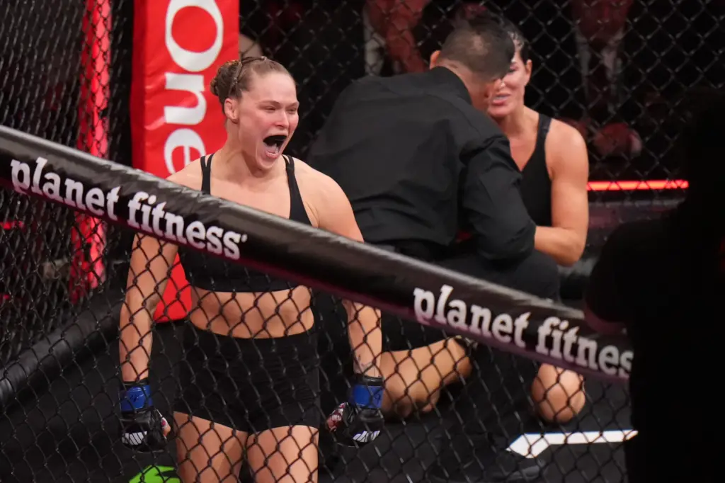Ronda Rousey, of the United States, left, celebrates after defeating...
