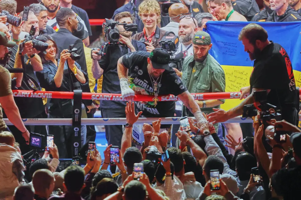 Oleksandr Usyk, center, greets his fans after winning his boxing...