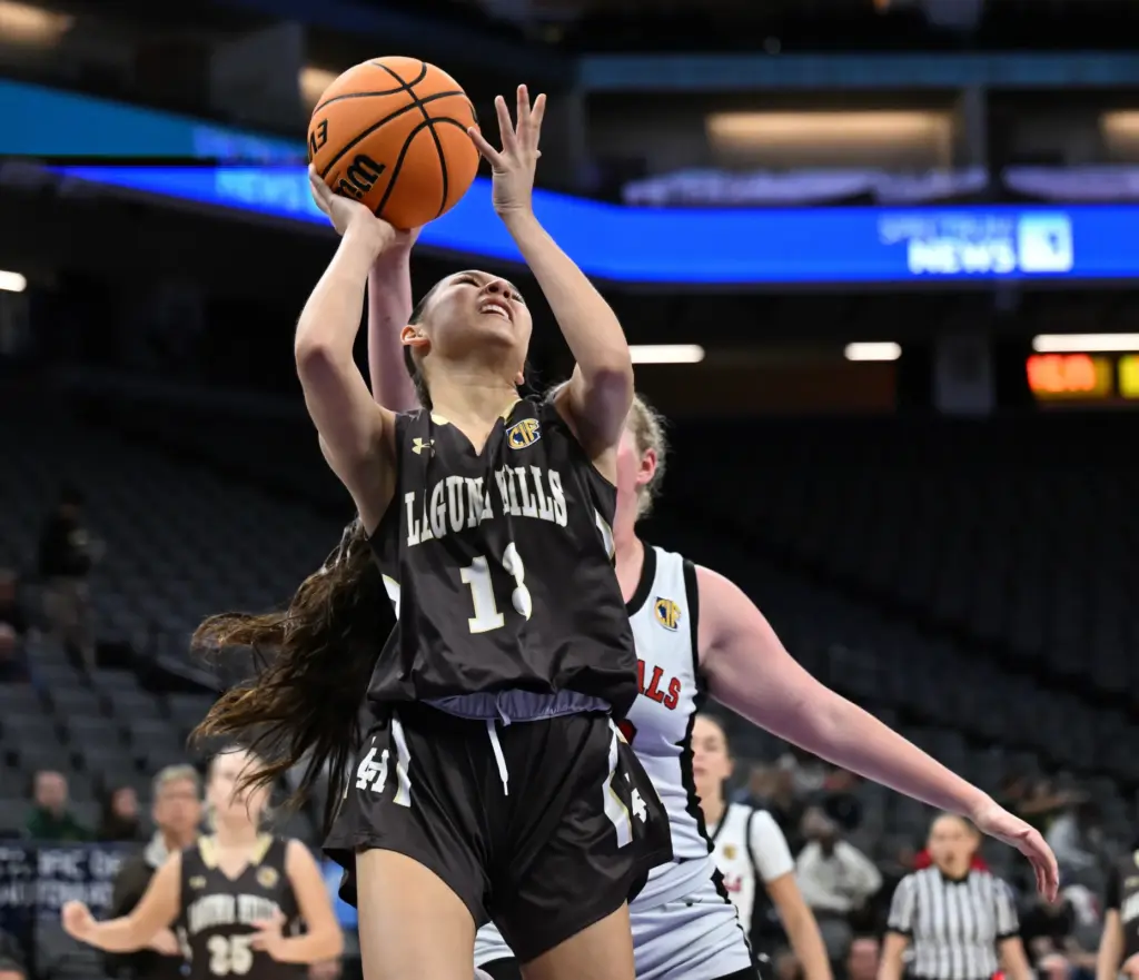 Lena Goodman #13 of Laguna Hills drives to the basket...