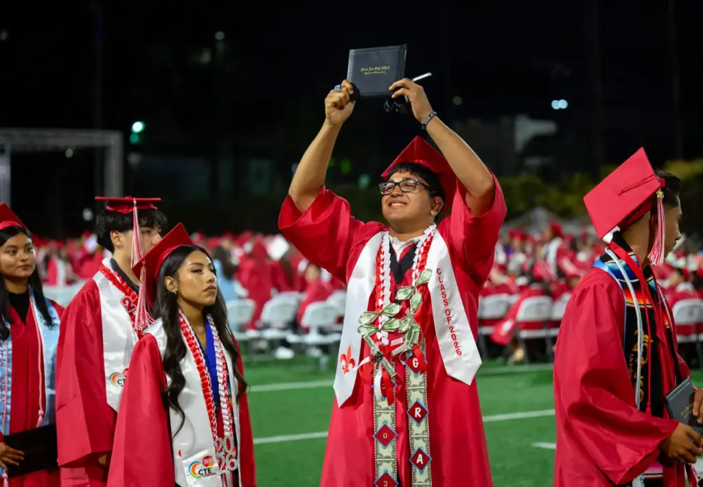 Jasper Garcia shows off his diploma during the Santa Ana...