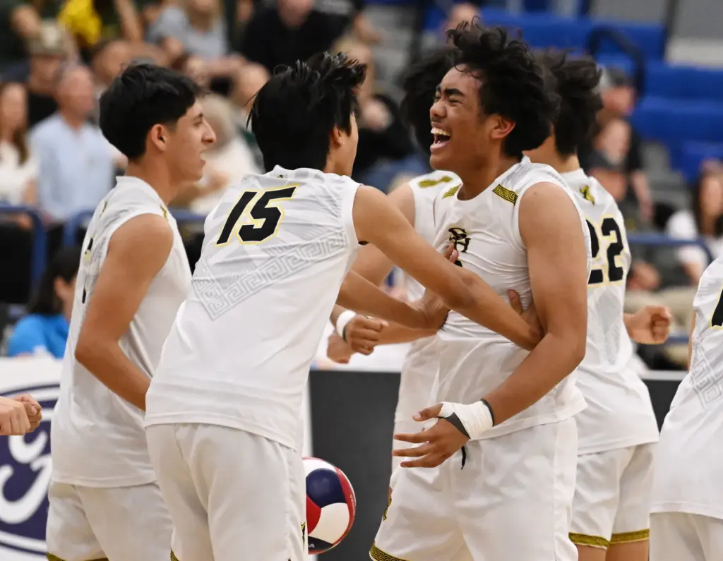 Jadyn Salud, right, of the Sunny Hills Lancers with teammates...