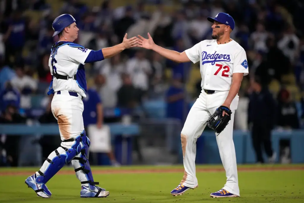 Dodgers catcher Will Smith, left, and infielder Miguel Rojas, who...
