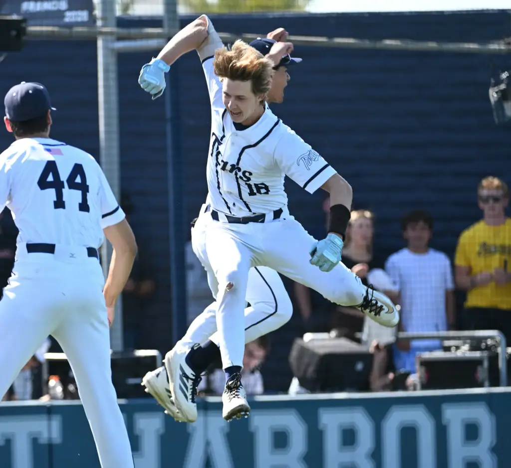 Henry Mann (18) of Newport Harbor leaps in celebration after...