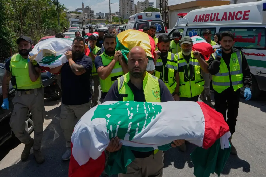 Mourners and paramedics carry the bodies of family members killed by Israeli airstrike