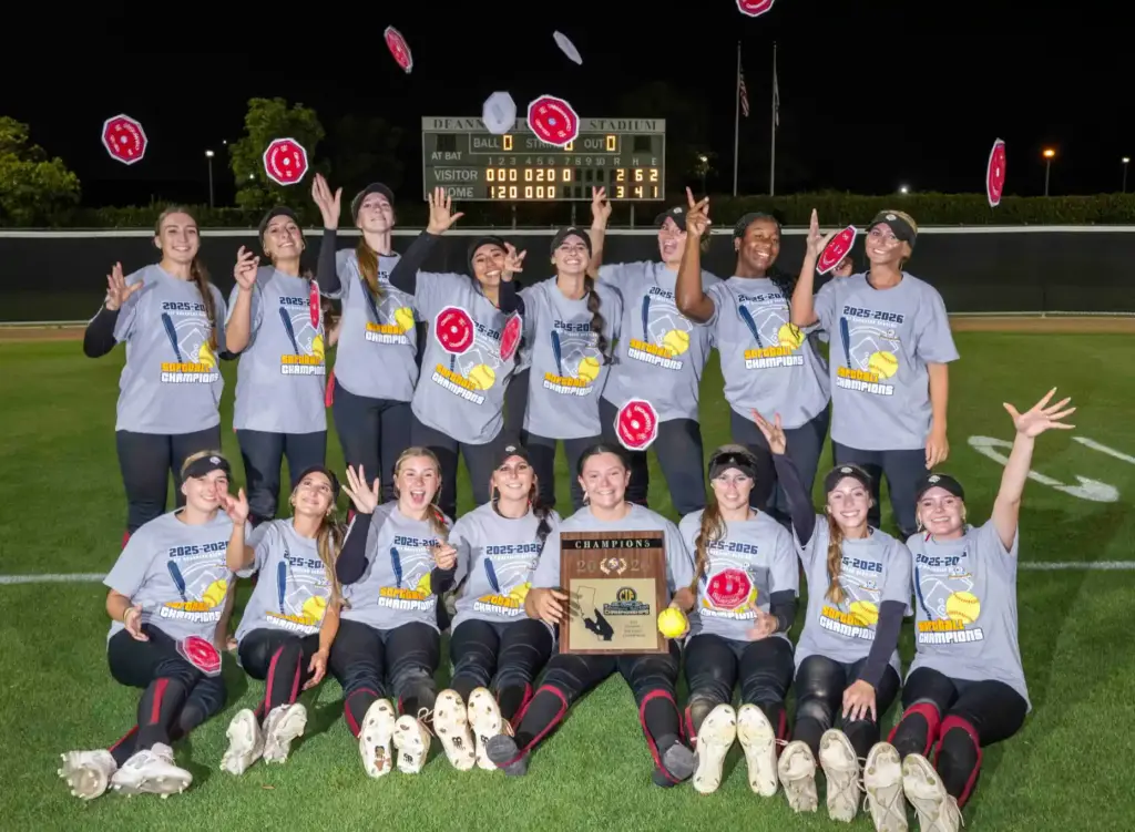 JSerra players celebrate by tossing their CIF patches in the...