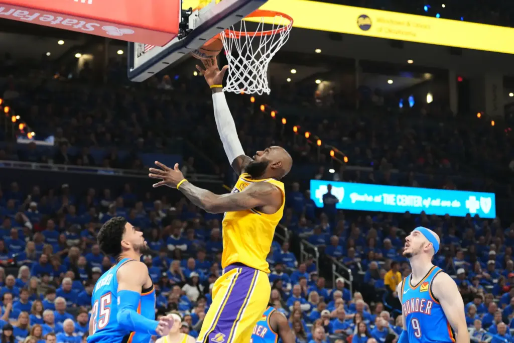 Lakers forward LeBron James shoots between the Oklahoma City Thunder’s...