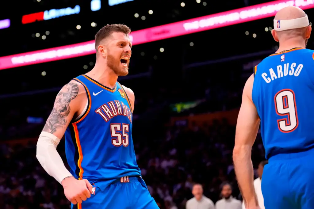 Oklahoma City Thunder guard Alex Caruso, right, celebrates his dunk...