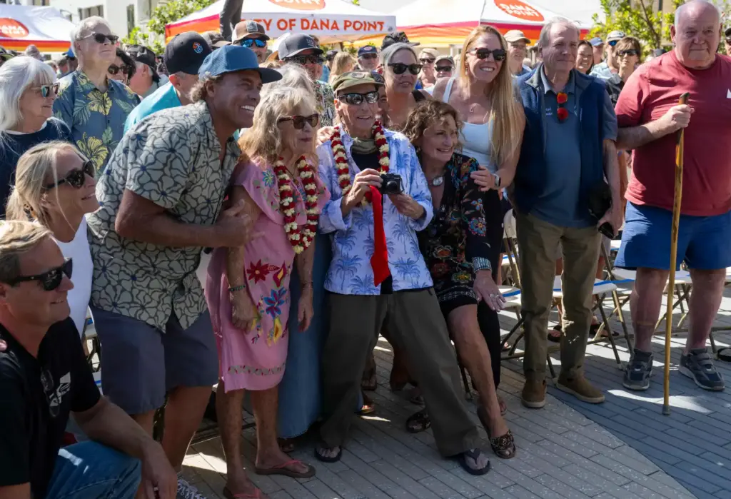 Surfer Mickey MuÃ±oz, center, has some fun posing for photos...