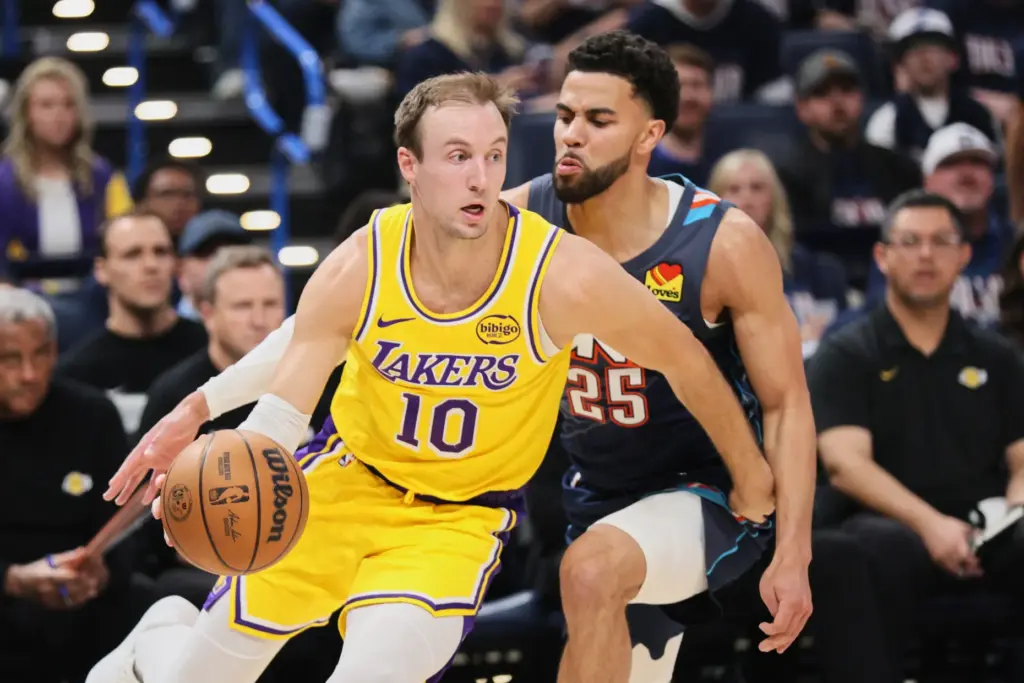 Los Angeles Lakers guard Luke Kennard (10) works to the...