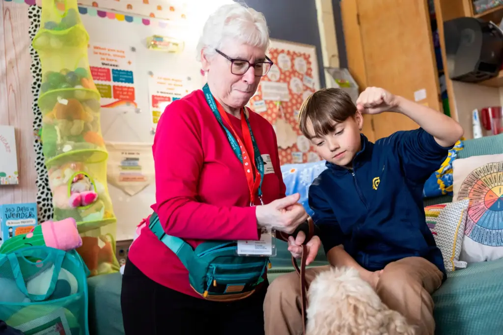 Linda Buchs-Hammonds, left, shows fifth grader Miles how to ask...