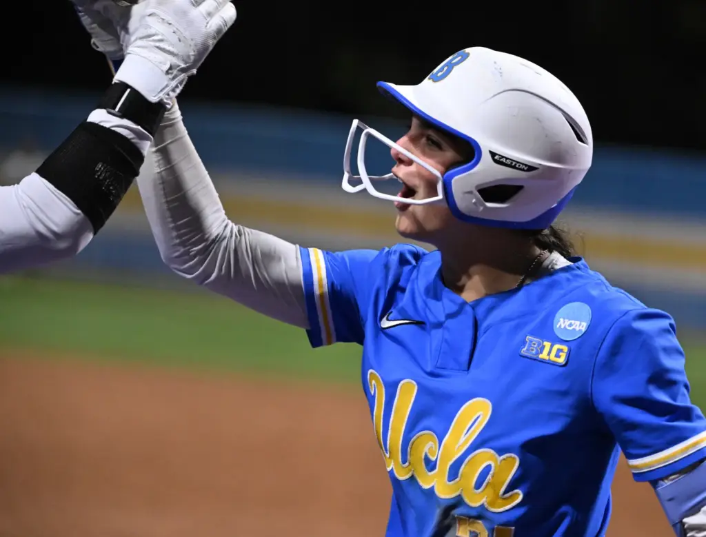 Aleena Garcia #21 of the UCLA Bruins reacts after hitting...