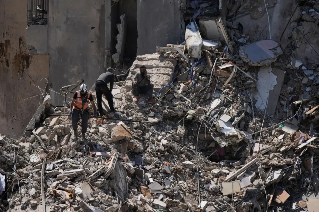 Rescue workers search through the rubble of a building destroyed in an Israeli airstrike in Lebanon.