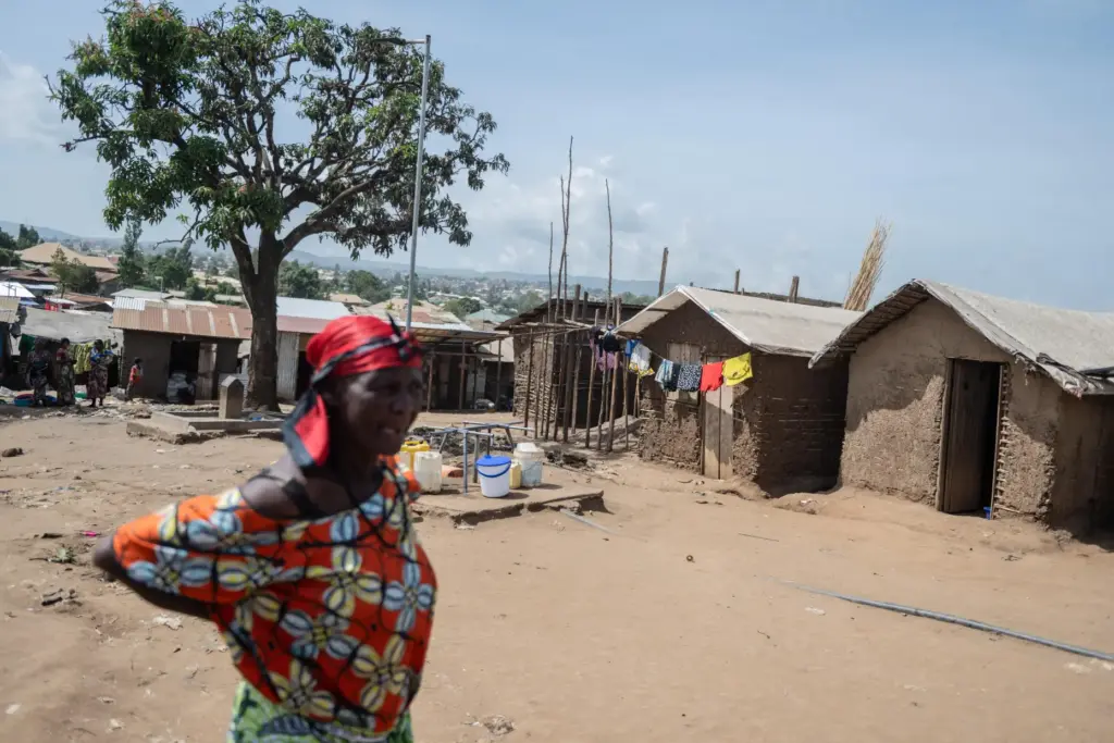 A woman walks in the camp.